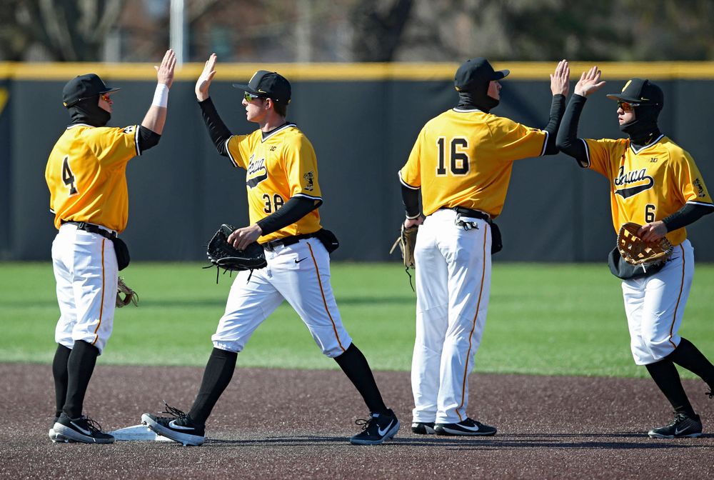Iowa Hawkeyes second baseman Mitchell Boe (4), left fielder Trenton Wallace (38), shortstop Tanner Wetrich (16), and center fielder Justin Jenkins (6) celebrate after winning their game against Illinois at Duane Banks Field in Iowa City on Sunday, Mar. 31, 2019. (Stephen Mally/hawkeyesports.com)