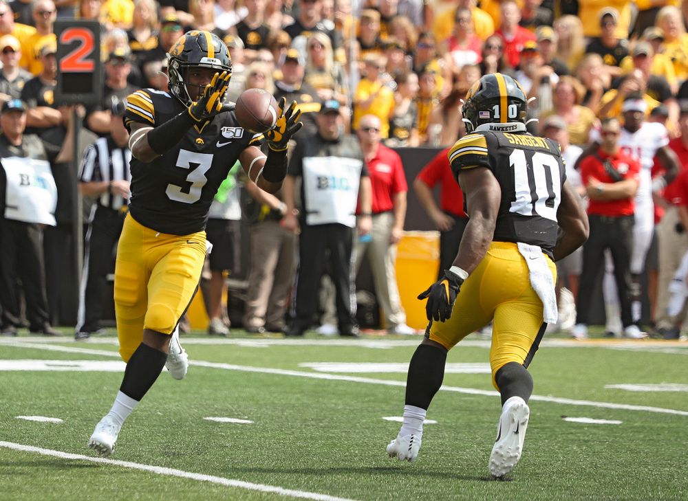 Iowa Hawkeyes running back Mekhi Sargent (10) tosses the ball to wide receiver Tyrone Tracy Jr. (3) during the third quarter of their Big Ten Conference football game at Kinnick Stadium in Iowa City on Saturday, Sep 7, 2019. (Stephen Mally/hawkeyesports.com)