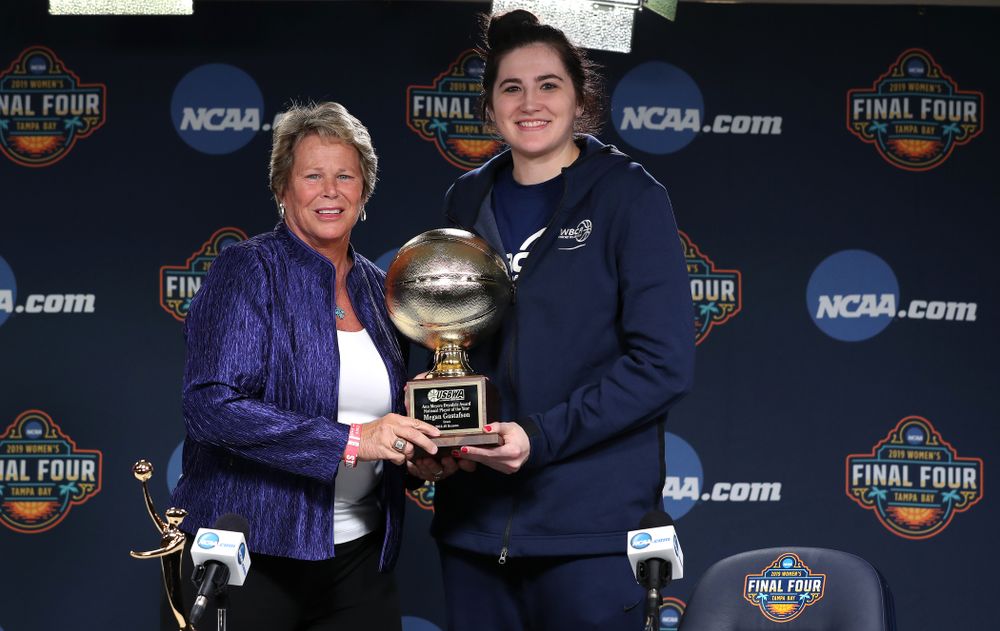 Iowa Hawkeyes forward Megan Gustafson (10) receives US Basketball Writers Association Ann Meyers Drysdale Player of the Year award from Ann Meyers Drysdale during a news conference Friday, April 5, 2019 at Amalie Arena in Tampa, FL. (Brian Ray/hawkeyesports.com)