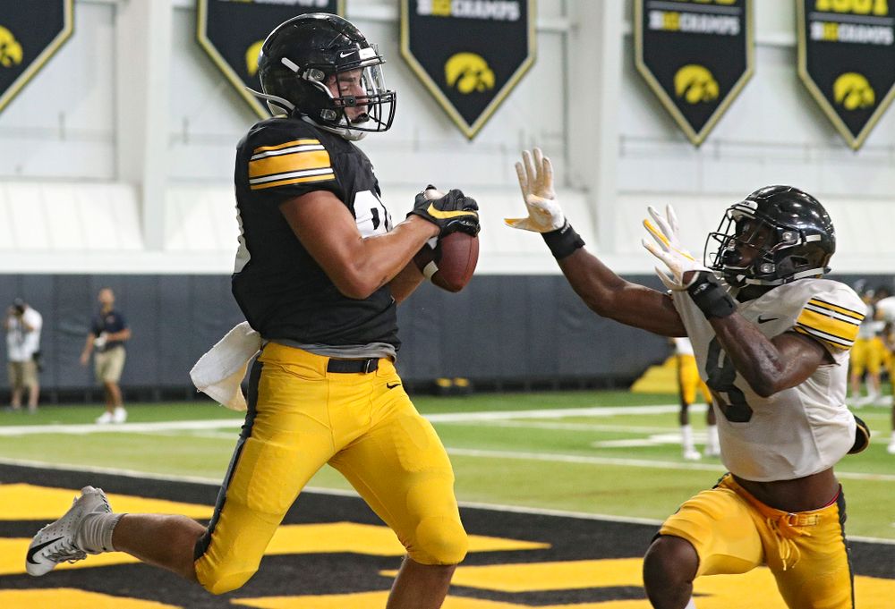 Iowa Hawkeyes wide receiver Nico Ragaini (89) pulls in a pass as defensive back Matt Hankins (8) defends during Fall Camp Practice No. 6 at the Hansen Football Performance Center in Iowa City on Thursday, Aug 8, 2019. (Stephen Mally/hawkeyesports.com)