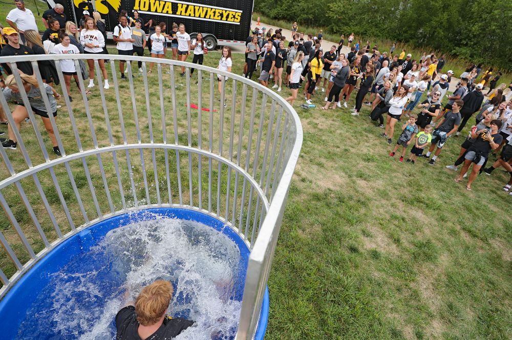 Iowa Women’s Tennis program coordinator Daniel Leitner drops into the water in the dunk tank during the Student-Athlete Kickoff outside the Karro Athletics Hall of Fame Building in Iowa City on Sunday, Aug 25, 2019. (Stephen Mally/hawkeyesports.com)