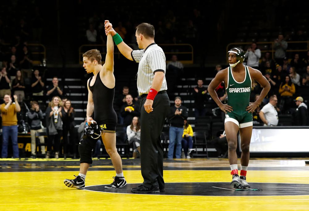 Iowa's Spencer Lee pins Michigan State's Rayvon Foley at 125 pounds. 