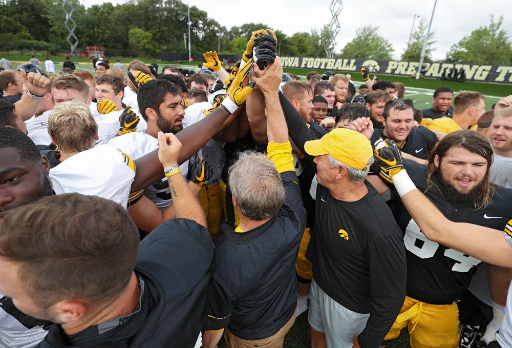 University of Iowa President Bruce Harreld and Iowa Hawkeyes head coach Kirk Ferentz huddle with the team during Fall Camp Practice No. 10 at the Hansen Football Performance Center in Iowa City on Tuesday, Aug 13, 2019. (Stephen Mally/hawkeyesports.com)