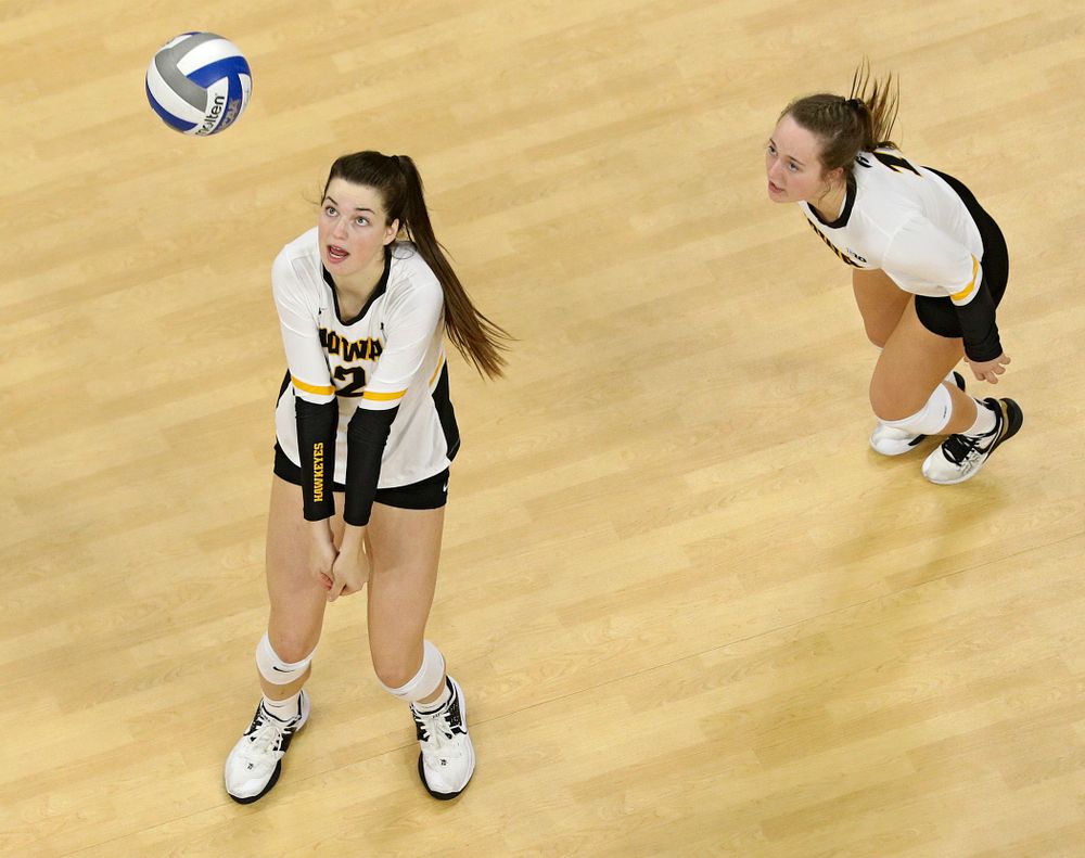 Iowa’s Courtney Buzzerio (from left) prepares to bump the ball as Joslyn Boyer looks on during the second set of their match at Carver-Hawkeye Arena in Iowa City on Saturday, Nov 30, 2019. (Stephen Mally/hawkeyesports.com)