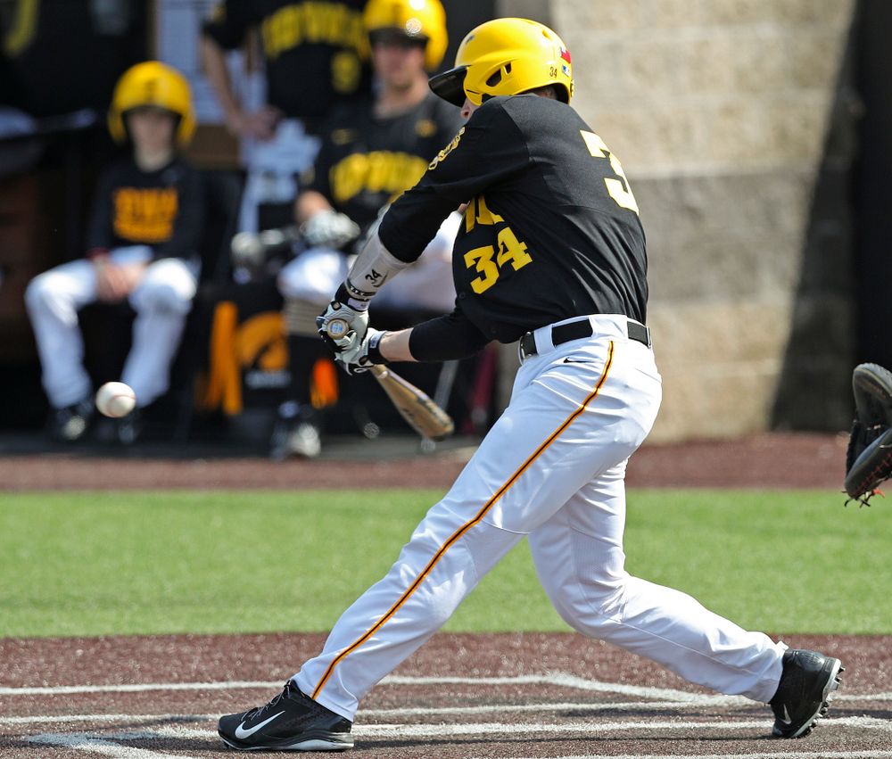 Iowa Hawkeyes catcher Austin Martin (34) drives a pitch for a hit during the third inning of their game against Rutgers at Duane Banks Field in Iowa City on Saturday, Apr. 6, 2019. (Stephen Mally/hawkeyesports.com)