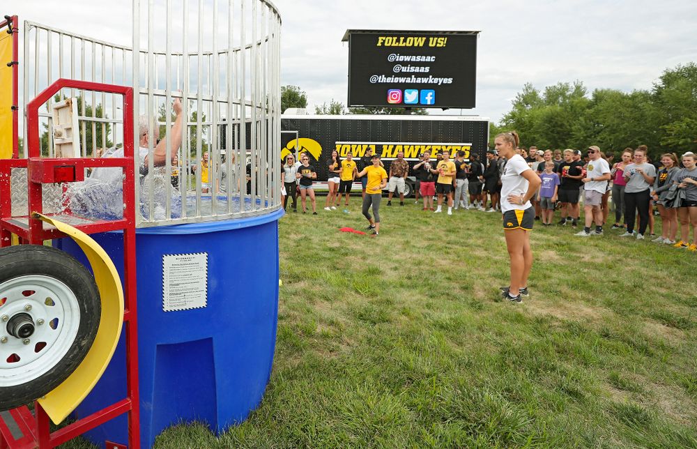 Iowa Softball’s Aralee Bogar sinks Swimming head coach Marc Long in the dunk tank during the Student-Athlete Kickoff outside the Karro Athletics Hall of Fame Building in Iowa City on Sunday, Aug 25, 2019. (Stephen Mally/hawkeyesports.com)