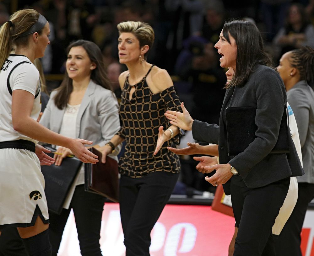 Iowa assistant coach Abby Stamp (right) gives a high-five to guard Makenzie Meyer (3) during the third quarter of their overtime win against Princeton at Carver-Hawkeye Arena in Iowa City on Wednesday, Nov 20, 2019. (Stephen Mally/hawkeyesports.com)