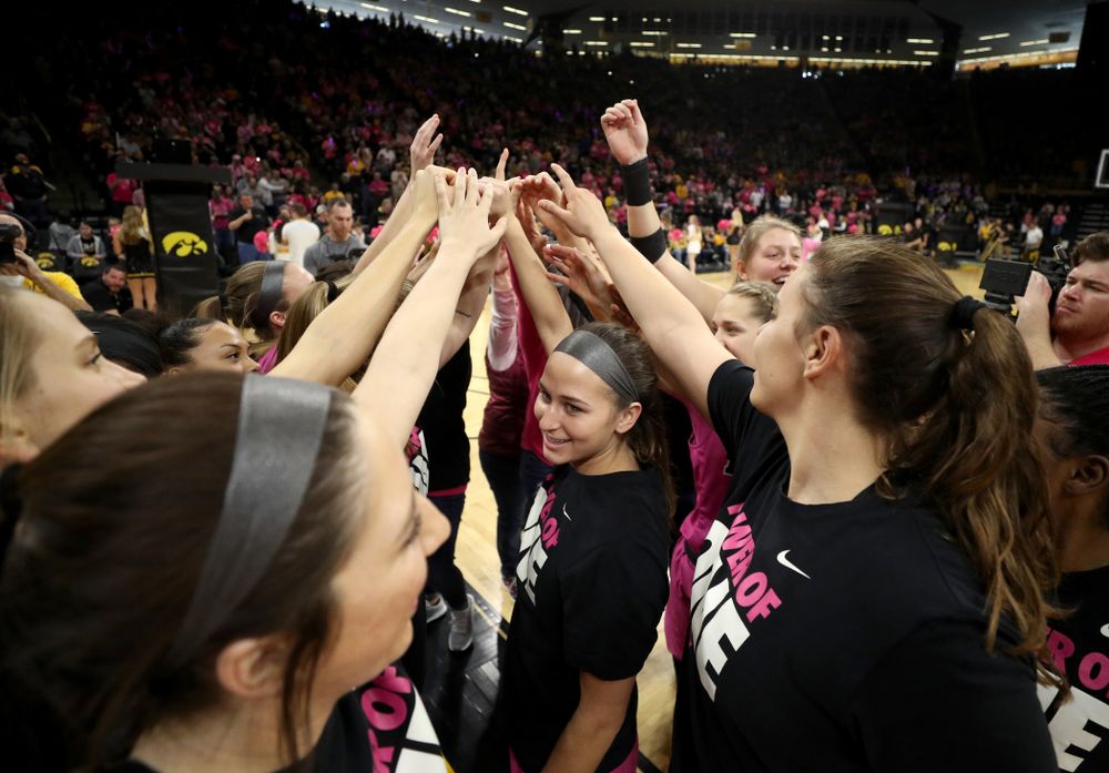 The Iowa Hawkeyes gather with women affected by breast cancer before their game against the Wisconsin Badgers Sunday, February 16, 2020 at Carver-Hawkeye Arena. (Brian Ray/hawkeyesports.com)