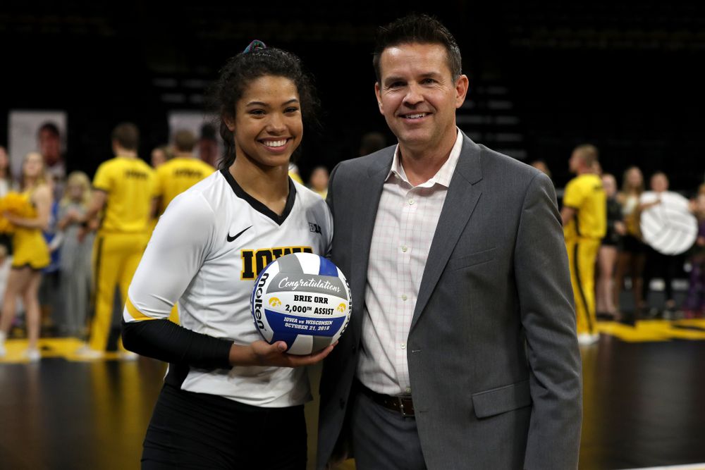 Iowa Hawkeyes setter Gabrielle Orr (7) receives a ball commemorating her 2,000th assist from head coach Bond Shymansky before their game against the Northwestern Wildcats Wednesday, October 24, 2018 at Carver-Hawkeye Arena. (Brian Ray/hawkeyesports.com)