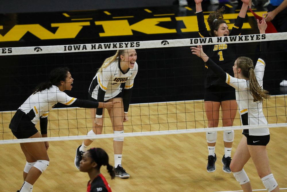 Iowa Hawkeyes setter Brie Orr (7), Iowa Hawkeyes outside hitter Cali Hoye (14) and Iowa Hawkeyes defensive specialist Molly Kelly (1) celebrate after winning a point during a match against Rutgers at Carver-Hawkeye Arena on November 2, 2018. (Tork Mason/hawkeyesports.com)