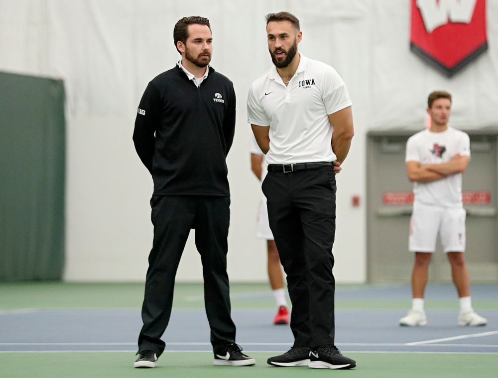 Iowa head coach Ross Wilson and assistant coach Lloyd Bruce-Burgess talk during their match at the Hawkeye Tennis and Recreation Complex in Iowa City on Thursday, January 16, 2020. (Stephen Mally/hawkeyesports.com)