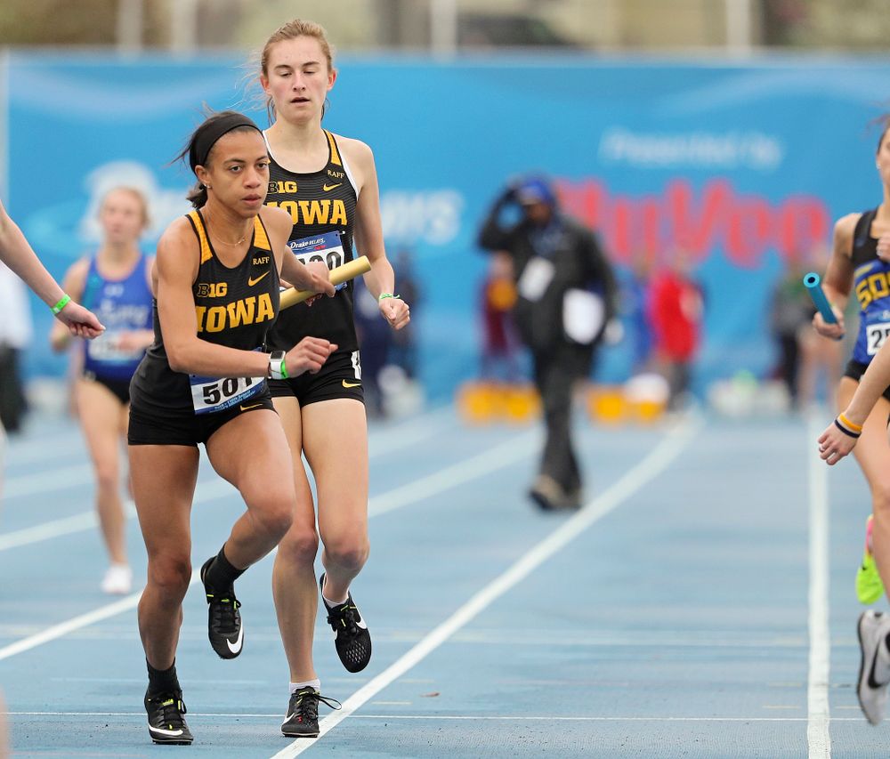 Iowa's Grace McCabe hands the baton off to Alexis Gay runs the women's distance medley relay event during the third day of the Drake Relays at Drake Stadium in Des Moines on Saturday, Apr. 27, 2019. (Stephen Mally/hawkeyesports.com)