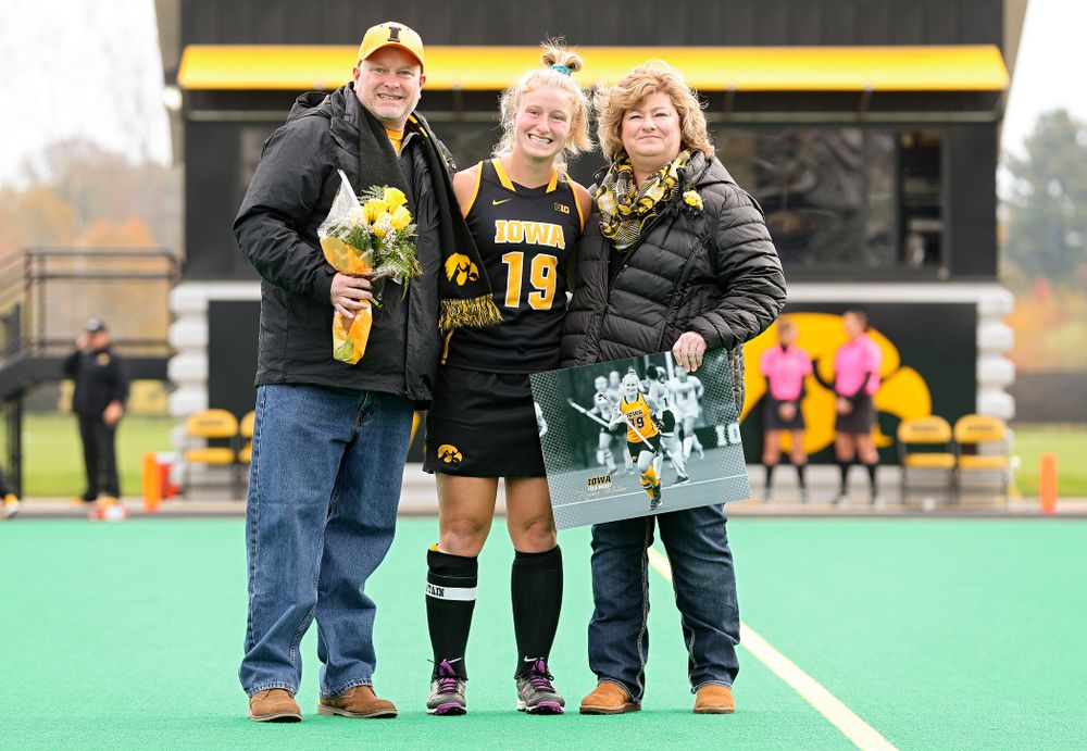 Iowa’s Ryley Miller (19) in honored with her parents on Senior Day before their game at Grant Field in Iowa City on Saturday, Oct 26, 2019. (Stephen Mally/hawkeyesports.com)