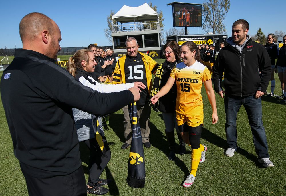 Iowa Hawkeyes forward Rose Ripslinger (15) is greeted by assistant coaches Katelyn Longino and Rade Tanaskovic during Senior Day ceremonies before a game against Northwestern at the Iowa Soccer Complex on October 21, 2018. (Tork Mason/hawkeyesports.com)