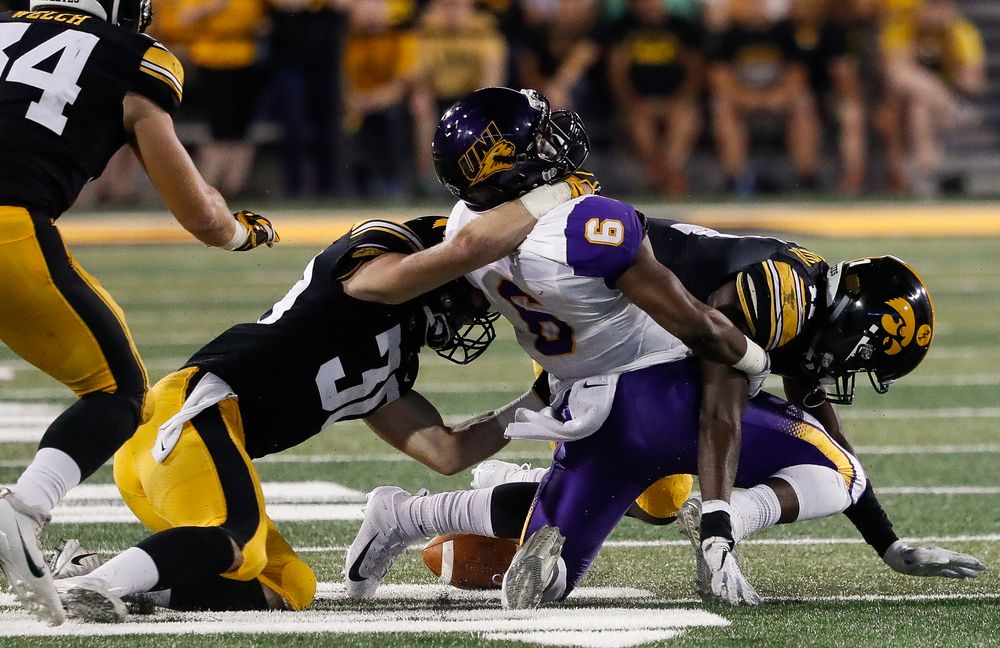 Iowa Hawkeyes defensive back Jake Gervase (30) and Iowa Hawkeyes defensive back Michael Ojemudia (11) combine to force a fumble during a game against Northern Iowa at Kinnick Stadium on September 15, 2018. (Tork Mason/hawkeyesports.com)