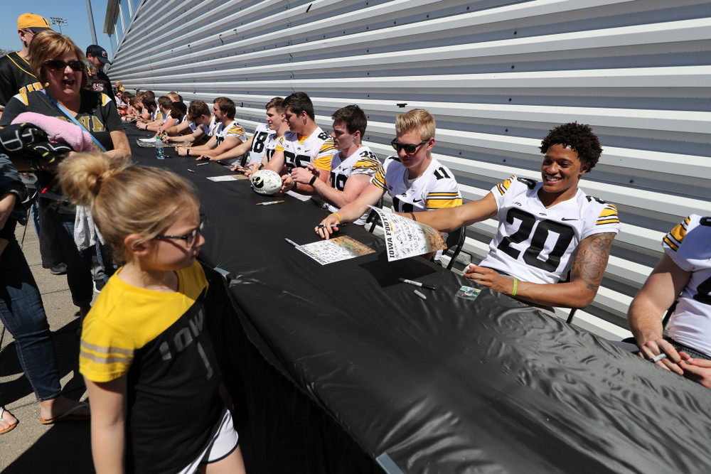 Members of the Iowa Football team sign autographs before the Iowa Hawkeyes game against the Nebraska Cornhuskers Saturday, April 20, 2019 at Duane Banks Field. (Brian Ray/hawkeyesports.com)