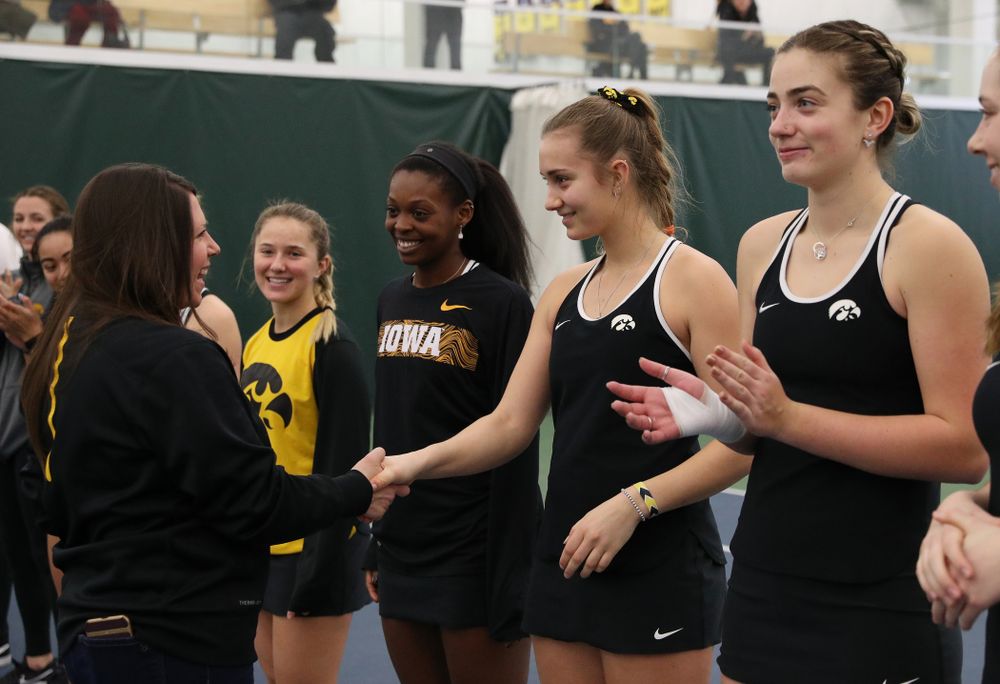 Academic Student Services Associate Director Kara Park congratulates Ashleigh Jacobs for earning a 3.0 GPA or better during the fall semester before their match against the Penn State Nittany Lions Sunday, February 24, 2019 at the Hawkeye Tennis and Recreation Complex. (Brian Ray/hawkeyesports.com)