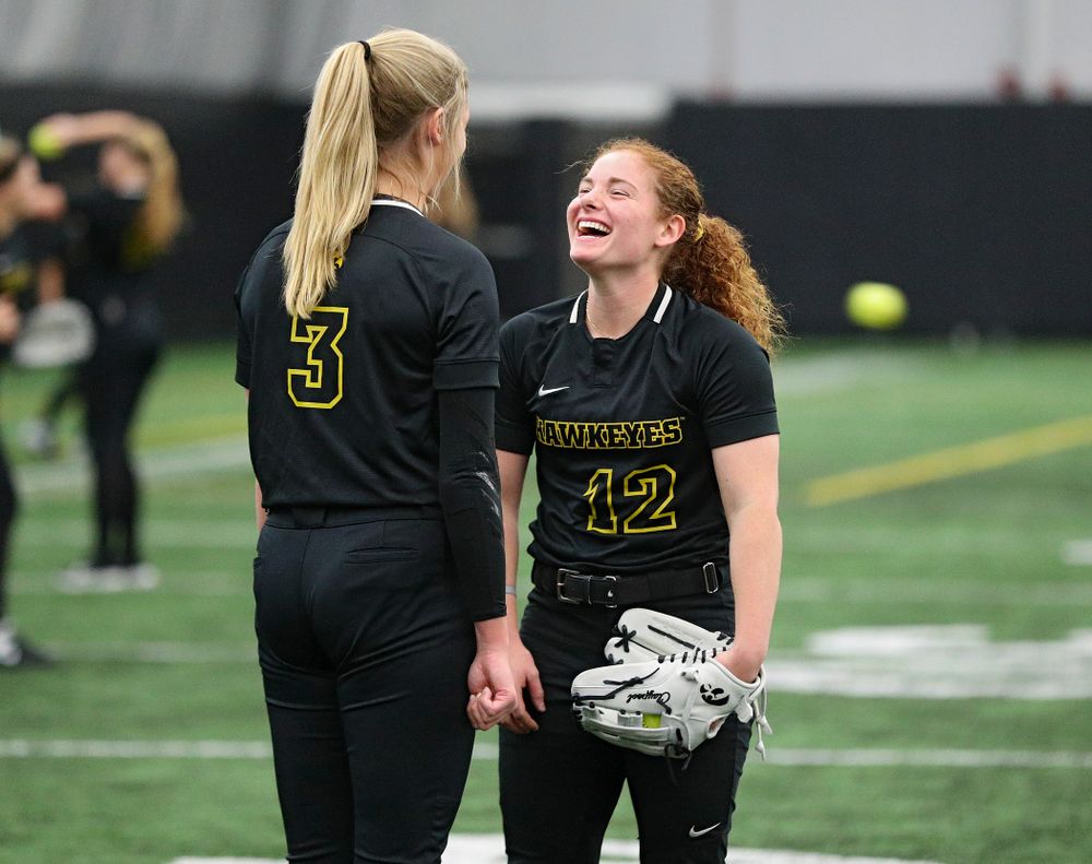 Iowa pitcher Allison Doocy (3) and catcher/infielder Kate Claypool (12) share a laugh during Iowa Softball Media Day at the Hawkeye Tennis and Recreation Complex in Iowa City on Thursday, January 30, 2020. (Stephen Mally/hawkeyesports.com)