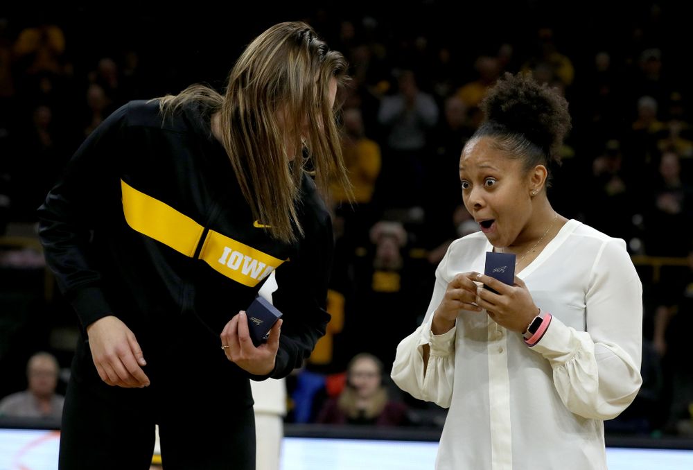 Former Hawkeye and Clemson graduate assistant Tania Davis and former Hawkeye Hannah Stewart react after receiving their against Big Ten Tournament championship rings before the Hawkeye game against Clemson Wednesday, December 4, 2019 at Carver-Hawkeye Arena. (Brian Ray/hawkeyesports.com)