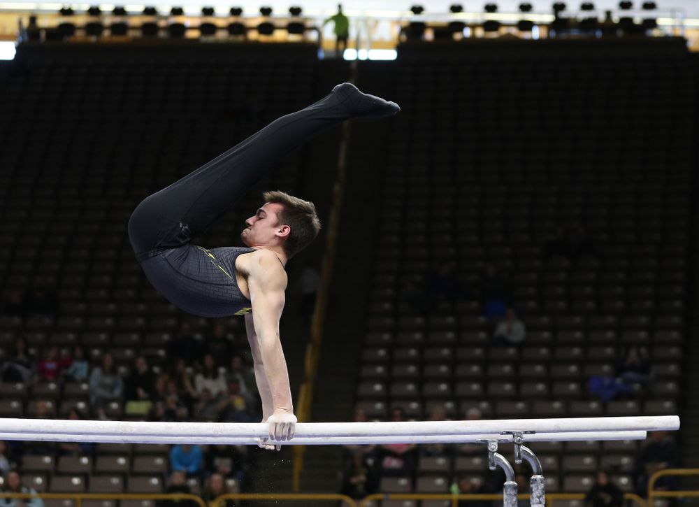 Iowa's Mitch Mandozzi competes on the parallel bars against the Ohio State Buckeyes  Saturday, March 16, 2019 at Carver-Hawkeye Arena.  (Brian Ray/hawkeyesports.com)