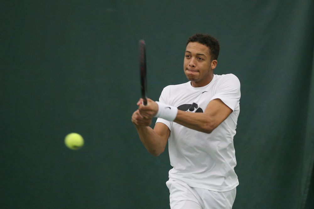 Iowa’s Oliver Okonkwo returns a hit during the Iowa men’s tennis meet vs Nebraska on Sunday, March 1, 2020 at the Hawkeye Tennis and Recreation Complex. (Lily Smith/hawkeyesports.com)