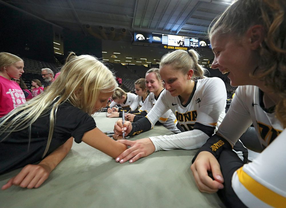 Iowa’s Maddie Slagle (15) autographs a young fan’s arm after their Big Ten/Pac-12 Challenge match against Colorado at Carver-Hawkeye Arena in Iowa City on Friday, Sep 6, 2019. (Stephen Mally/hawkeyesports.com)