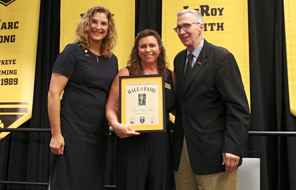 Barb Randall (from left), co-chair of the Varsity Club Advisory Committee, 2019 University of Iowa Athletics Hall of Fame inductee Diane Pohl, and Andy Piro, assistant athletics director and executive director of the Varsity Club, during the Hall of Fame Induction Ceremony at the Coralville Marriott Hotel and Conference Center in Coralville on Friday, Aug 30, 2019. (Stephen Mally/hawkeyesports.com)