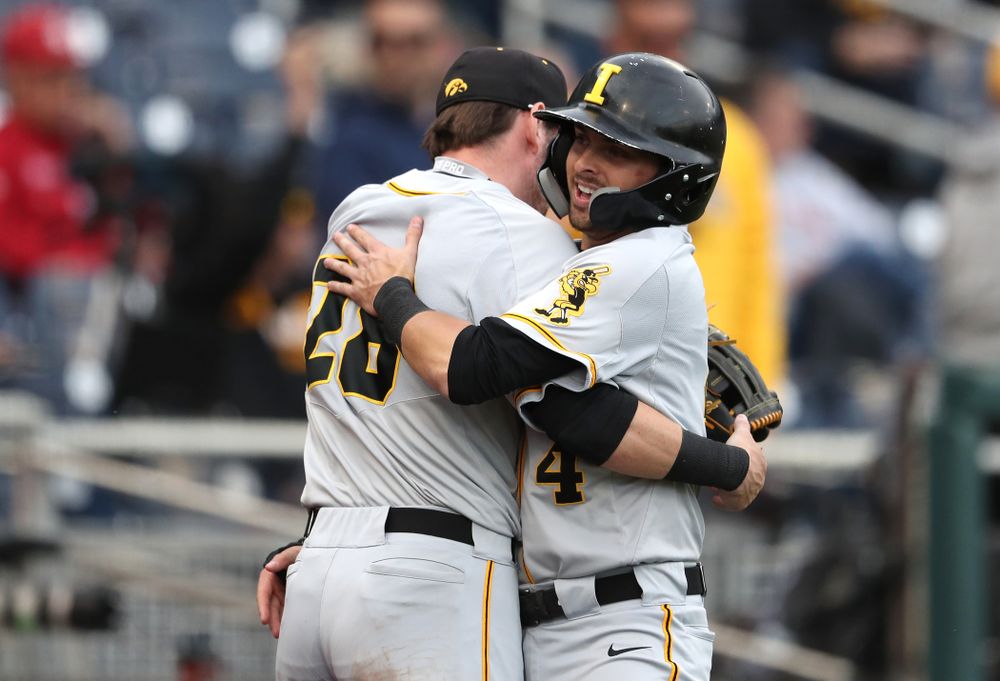 Iowa Hawkeyes infielder Mitchell Boe (4) hugs Chris Whelan (28) after scoring against the Indiana Hoosiers in the first round of the Big Ten Baseball Tournament Wednesday, May 22, 2019 at TD Ameritrade Park in Omaha, Neb. (Brian Ray/hawkeyesports.com)