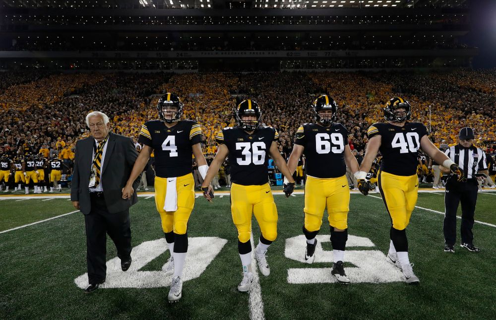 Honorary Captain Tom Moore along with captains quarterback Nate Stanley (4), fullback Brady Ross (36), offensive lineman Keegan Render (69), and defensive end Parker Hesse (40) before their game against the Wisconsin Badgers Saturday, September 22, 2018 at Kinnick Stadium. (Brian Ray/hawkeyesports.com)