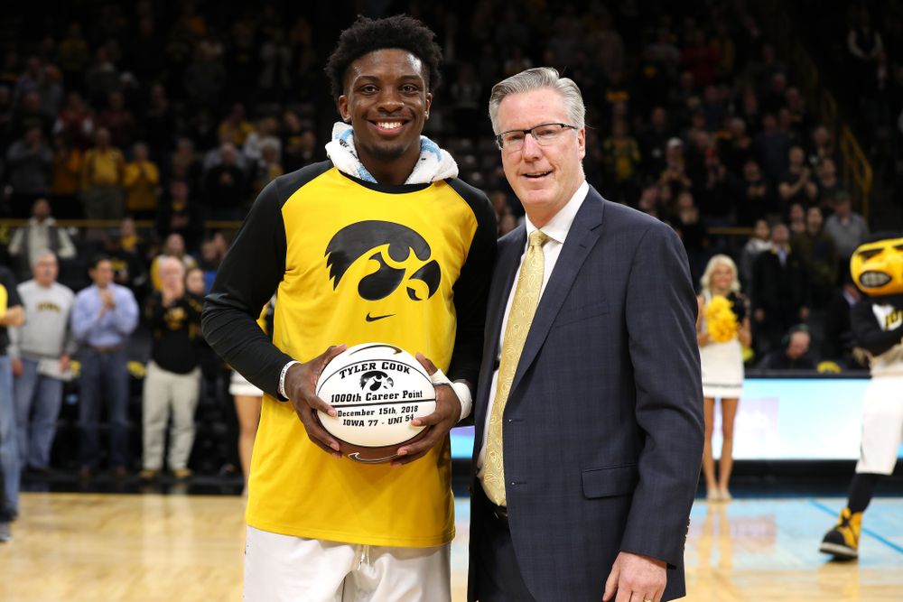 Iowa Hawkeyes forward Tyler Cook (25) receives a ball commemorating his 1,000th career point from Iowa Hawkeyes head coach Fran McCaffery before their game against the Western Carolina Catamounts Tuesday, December 18, 2018 at Carver-Hawkeye Arena. (Brian Ray/hawkeyesports.com)