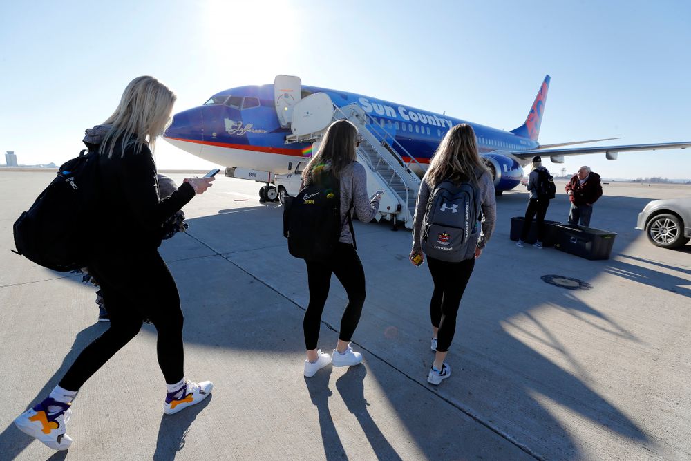 Iowa Hawkeyes guard Makenzie Meyer (3), guard Kathleen Doyle (22), and forward Hannah Stewart (21) walk to the team's plane as they travel to Los Angeles for the first round of the 2018 NCAA Tournament Thursday, March 15, 2018 at the Eastern Iowa Airport. (Brian Ray/hawkeyesports.com)
