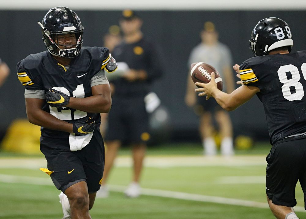 Iowa Hawkeyes running back Ivory Kelly-Martin (21) flips the ball to wide receiver Nico Ragaini (89) during Fall Camp Practice No. 9 at the Hansen Football Performance Center in Iowa City on Monday, Aug 12, 2019. (Stephen Mally/hawkeyesports.com)