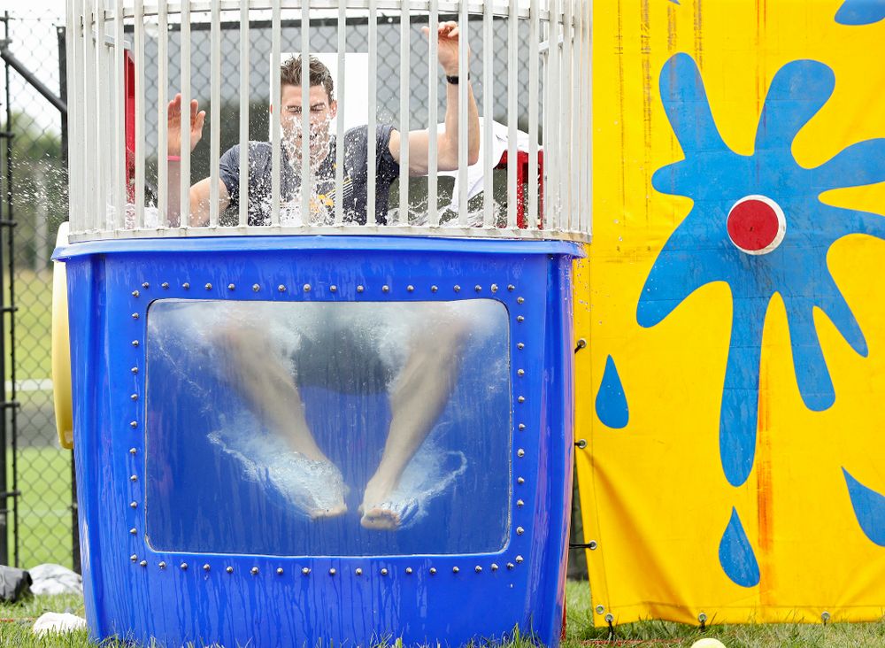 Iowa assistant strength and conditioning coach Cody Roberts drops into the water in the dunk tank during the Student-Athlete Kickoff outside the Karro Athletics Hall of Fame Building in Iowa City on Sunday, Aug 25, 2019. (Stephen Mally/hawkeyesports.com)