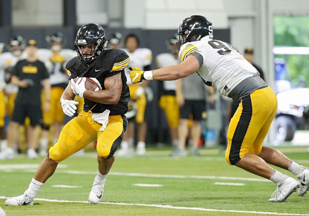 Iowa Hawkeyes running back Toren Young (28) gets around defensive end A.J. Epenesa (94) during Fall Camp Practice No. 6 at the Hansen Football Performance Center in Iowa City on Thursday, Aug 8, 2019. (Stephen Mally/hawkeyesports.com)