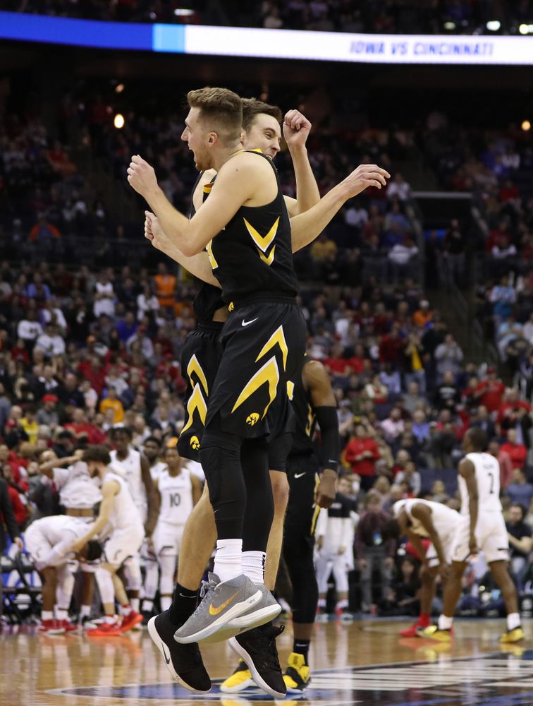 Iowa Hawkeyes guard Jordan Bohannon (3) and forward Nicholas Baer (51) against the Cincinnati Bearcats in the first round of the 2019 NCAA Men's Basketball Tournament Friday, March 22, 2019 at Nationwide Arena in Columbus, Ohio. (Brian Ray/hawkeyesports.com)