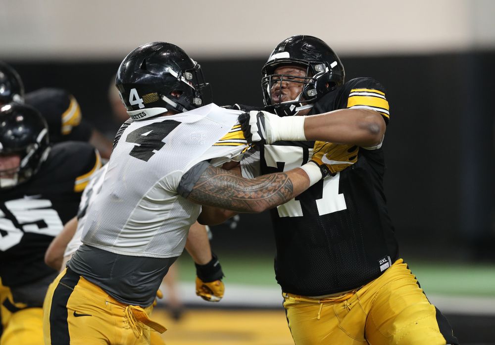 Iowa Hawkeyes defensive end A.J. Epenesa (94) and offensive lineman Alaric Jackson (77) uring Fall Camp Practice No. 6 Thursday, August 8, 2019 at the Ronald D. and Margaret L. Kenyon Football Practice Facility. (Brian Ray/hawkeyesports.com)