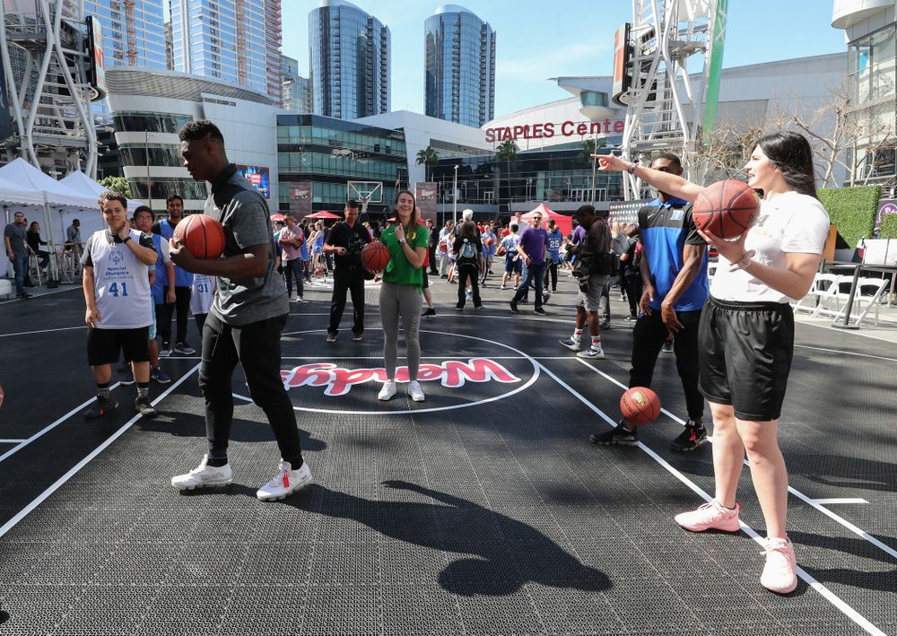 Iowa Hawkeyes forward Megan Gustafson (10) runs a drill with Zion Williamson during a Special Olympics event Friday, April 12, 2019 as part of the ESPN College Basketball Awards in the XBOX Plaza at LA Live.  (Brian Ray/hawkeyesports.com)