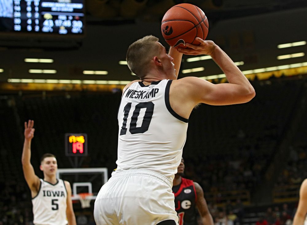 Iowa Hawkeyes guard Joe Wieskamp (10) makes a 3-pointer as guard CJ Fredrick (5) holds up three fingers as he starts to celebrate during the second half of their game at Carver-Hawkeye Arena in Iowa City on Friday, Nov 8, 2019. (Stephen Mally/hawkeyesports.com)