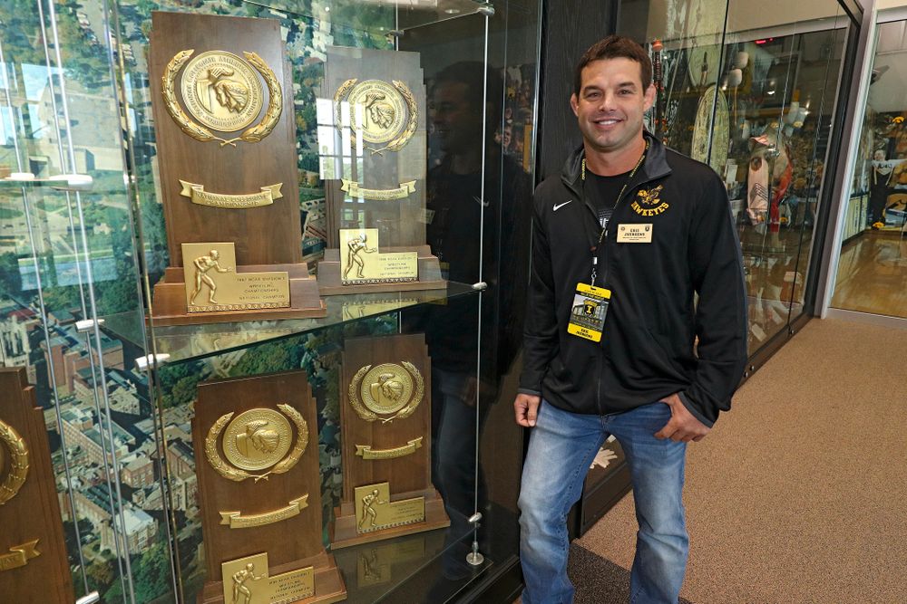 2019 University of Iowa Athletics Hall of Fame inductee Eric Juergens stands by some of the NCAA National Championship trophies he helped win at the University of Iowa Athletics Hall of Fame in Iowa City on Friday, Aug 30, 2019. (Stephen Mally/hawkeyesports.com)
