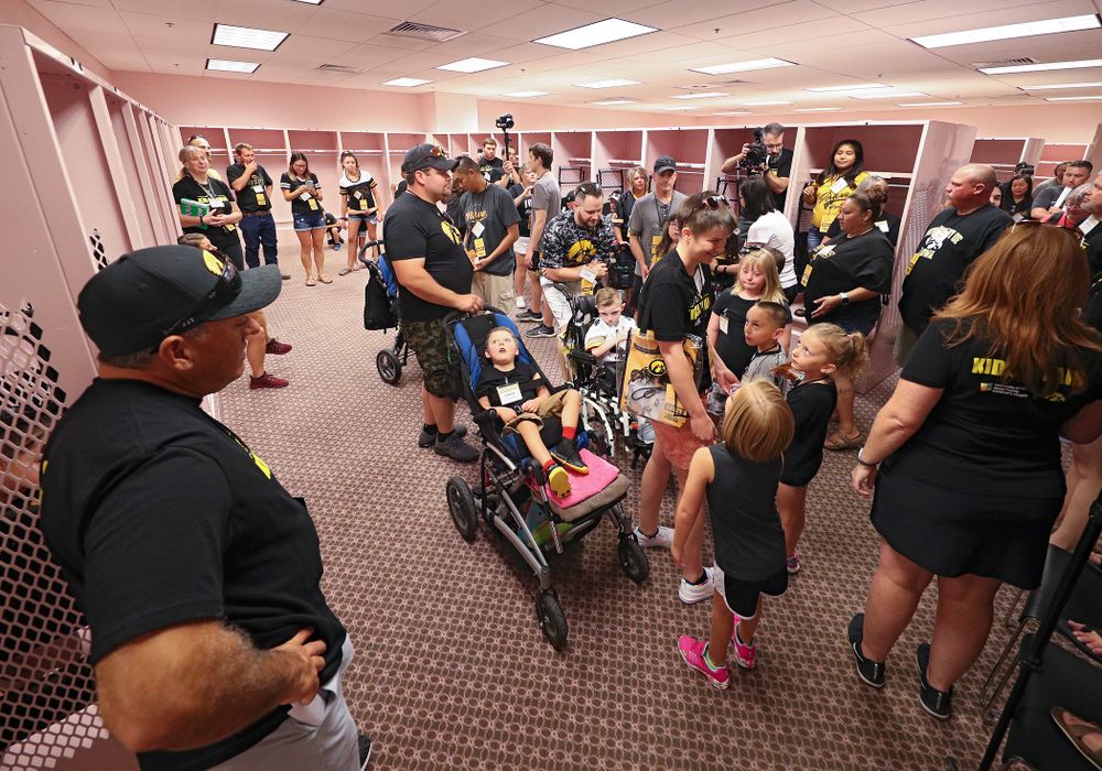 Kid Captains and their families tour the visitor’s pink locker room during Kids Day at Kinnick Stadium in Iowa City on Saturday, Aug 10, 2019. (Stephen Mally/hawkeyesports.com)