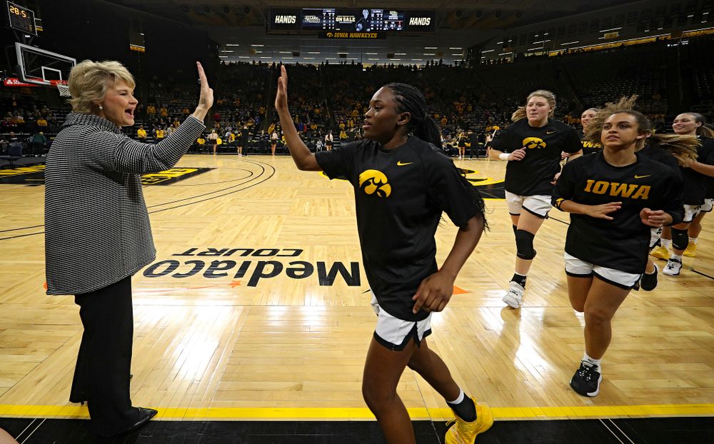 Iowa Hawkeyes head coach Lisa Bluder gives guard Tomi Taiwo (1) a high-five before their game at Carver-Hawkeye Arena in Iowa City on Tuesday, December 31, 2019. (Stephen Mally/hawkeyesports.com)
