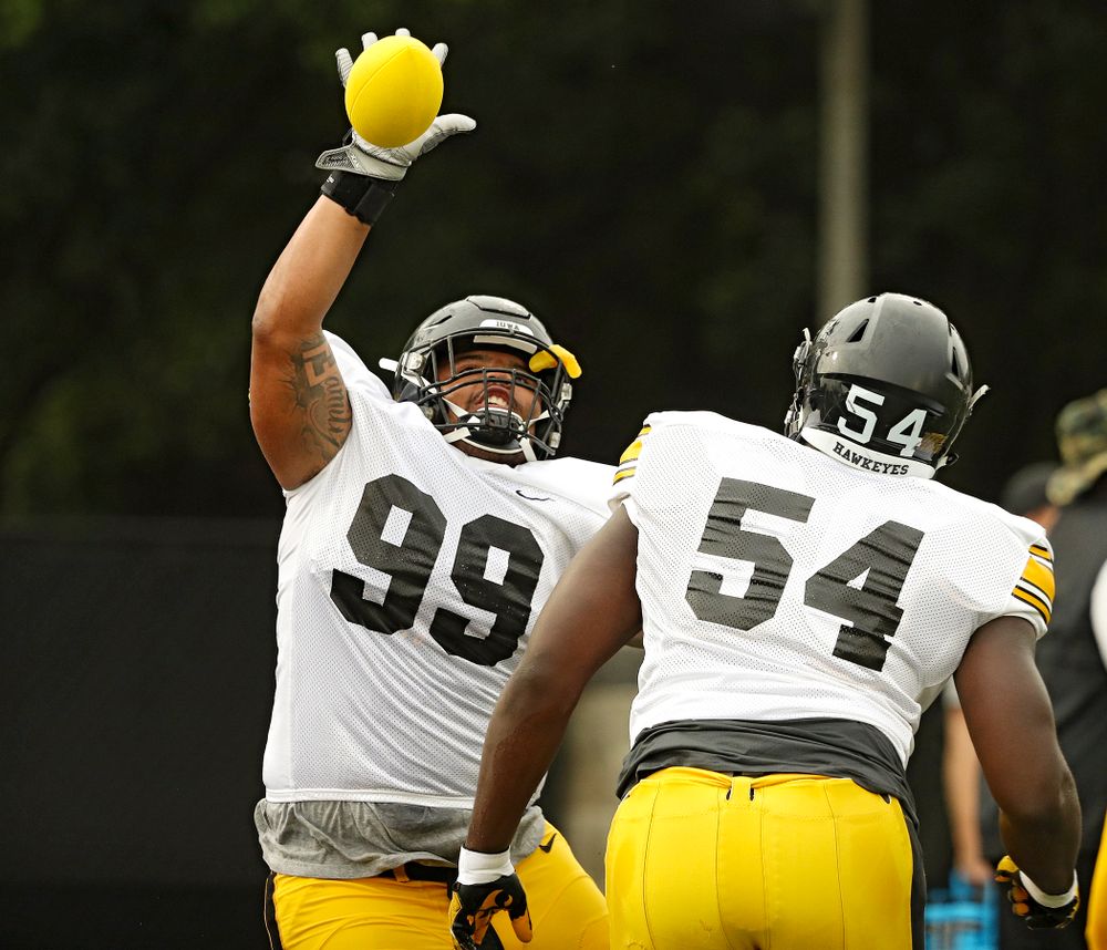 Iowa Hawkeyes defensive lineman Noah Shannon (99) knocks down a ball as the runs a drill with defensive tackle Daviyon Nixon (54) durning Fall Camp Practice No. 17 at the Hansen Football Performance Center in Iowa City on Wednesday, Aug 21, 2019. (Stephen Mally/hawkeyesports.com)