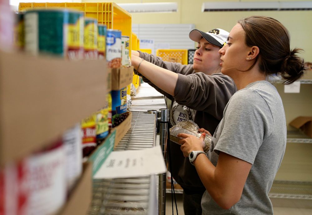 Iowa women's swimming and diving teammates clean the Coralville Community Food Pantry during the 21st annual ISAAC Hawkeye Day of Caring in Coralville on Sunday, Apr. 28, 2019. (Stephen Mally/hawkeyesports.com)