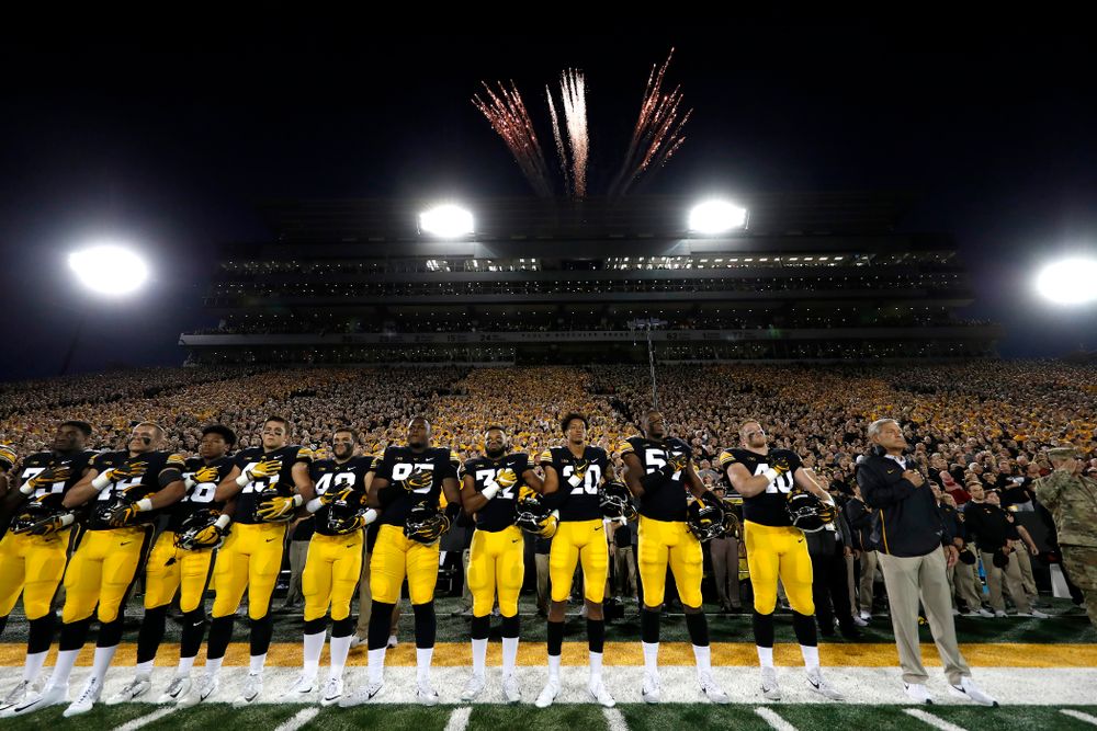 The Iowa Hawkeyes stand for the National Anthem before their game against the Wisconsin Badgers Saturday, September 22, 2018 at Kinnick Stadium. (Brian Ray/hawkeyesports.com)