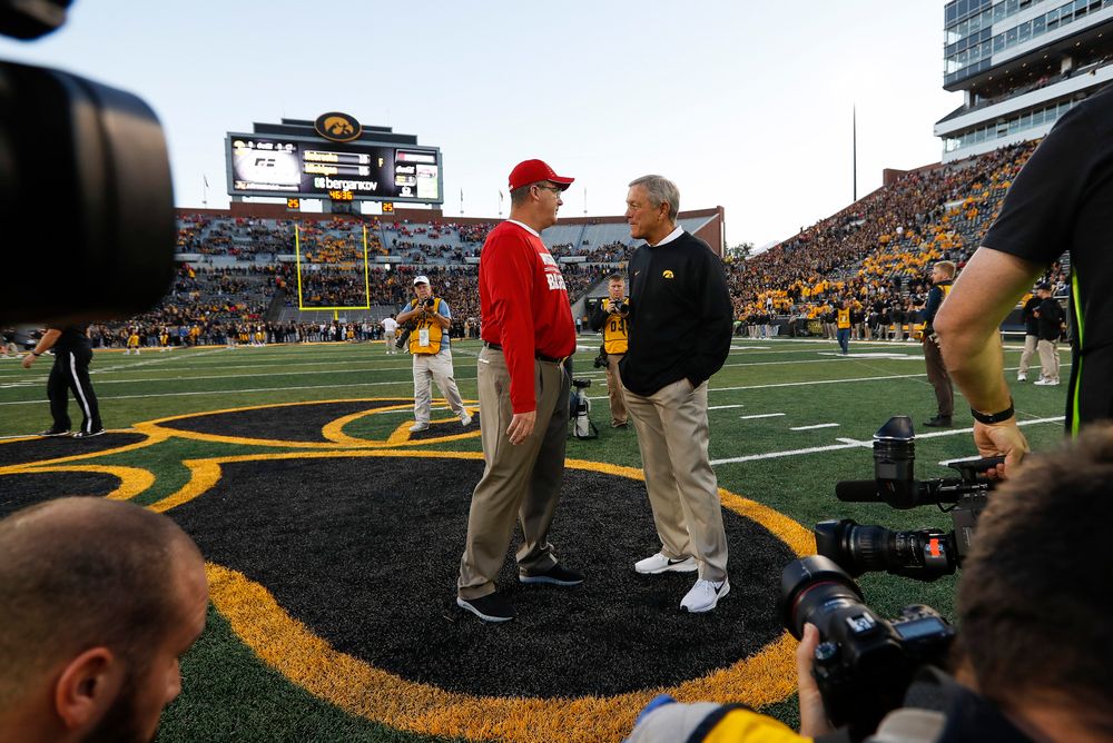 Iowa Hawkeyes head coach Kirk Ferentz meets with Wisconsin Badgers head coach Paul Chryst before a game against Wisconsin at Kinnick Stadium on September 22, 2018. (Tork Mason/hawkeyesports.com)