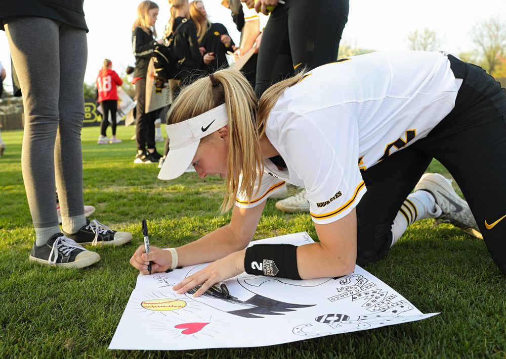 Iowa's Aralee Bogar (2) signs a poster for a fan after winning their game against Ohio State at Pearl Field in Iowa City on Friday, May. 3, 2019. (Stephen Mally/hawkeyesports.com)