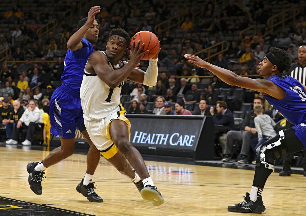 Iowa Hawkeyes guard Joe Toussaint (1) drives between two defenders during the first half of their exhibition game against Lindsey Wilson College at Carver-Hawkeye Arena in Iowa City on Monday, Nov 4, 2019. (Stephen Mally/hawkeyesports.com)