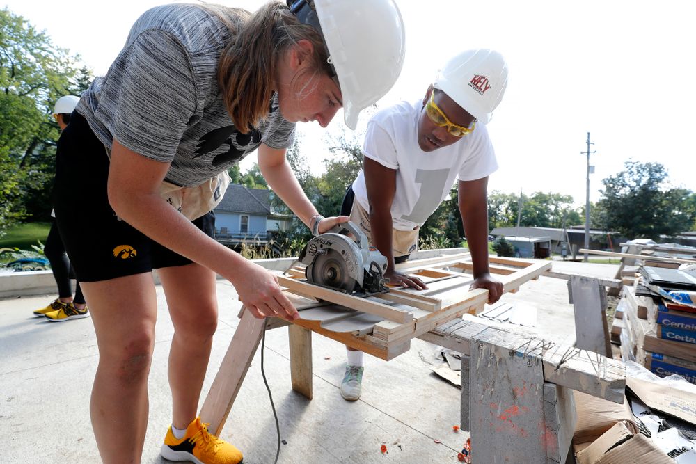 Iowa Hawkeyes guard Kate Martin (20) and guard Zion Sanders (24) work on the Habitat for Humanity Women's Build Wednesday, September 26, 2018 in Iowa City. (Brian Ray/hawkeyesports.com)
