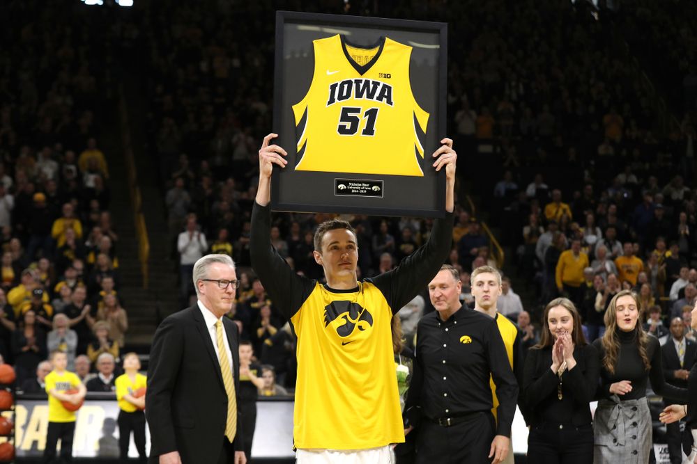 Iowa Hawkeyes forward Nicholas Baer (51) holds up his frames jersey during senior day activities before their game against the Rutgers Scarlet Knights  Saturday, March 2, 2019 at Carver-Hawkeye Arena. (Brian Ray/hawkeyesports.com)