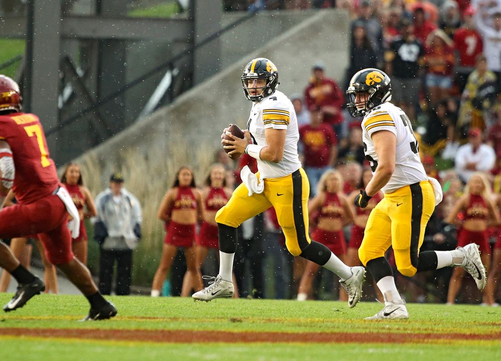 Iowa Hawkeyes quarterback Nate Stanley (4) looks to throw as he rolls out while fullback Brady Ross (36) looks on during the first quarter of their Iowa Corn Cy-Hawk Series game at Jack Trice Stadium in Ames on Saturday, Sep 14, 2019. (Stephen Mally/hawkeyesports.com)